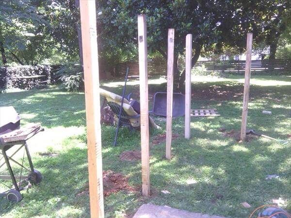 fixing the wooden pallet fence supports