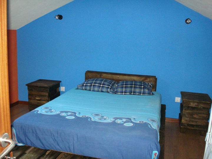 upcycled wooden pallet bed with headboard