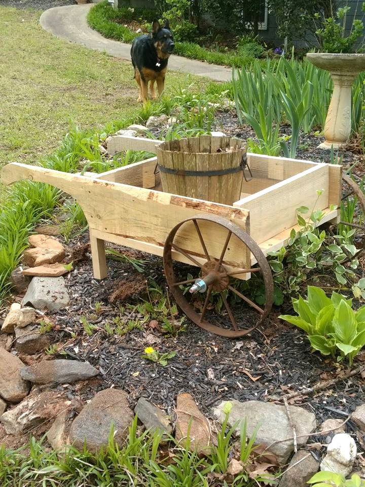 wooden pallet and old cart wheel wheelbarrow