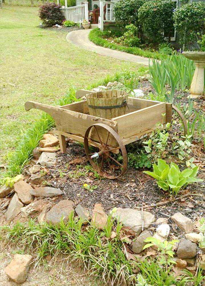 handcrafted wooden pallet and old cart wheels wheelbarrow