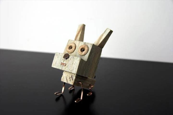 repurposed wooden pallet and old metal puppy sculpture